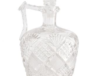 240
An American Brilliant Cut Glass Whiskey Jug
Late 19th/early 20th Century
The Brilliant cut glass handled whiskey jug and stopper with fine crosshatching, strawberry diamond cuts, fan motifs, cut ovals, a hobstar base, and handle with facet-cut patterning
9" H x 5.25" Dia.
Estimate: $600 - $800