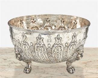 245
An English Sterling Silver Fruit Bowl
Circa 1818-1819
Marked for sterling
The sterling silver bowl with reeded rim and repousse foliate motifs raised on three ball and claw feet surmounted by lion masks, monogrammed and engraved with lion rampant
7.5" H x 12.25" Dia.
78.44 oz. troy approximately
Estimate: $1,000 - $1,500