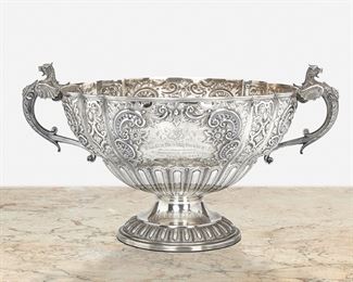 246
An English Sterling Silver Handled Bowl
1891
Marked for sterling
The sterling silver bowl with opposed winged lion handles raised on a pedestal base with repousse and chased floral motifs and gadrooning throughout, with engraved heraldic devices and commemorative inscription
8" H x 14.75" W x 11" D
39.29 oz. troy approximately
Estimate: $500 - $700