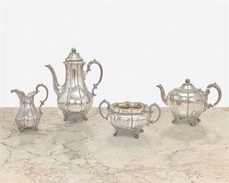247
An English Sterling Silver Coffee And Tea Service
Circa 1853; London, England
Marked for sterling
Each pumpkin-form raised on foliate feet and engraved with Tudor rose and stag antler emblems, comprising a coffee pot (11" H x 8.5" W x 5.5" D), a teapot (6.5" H x 10" W x 6" D), a creamer (6.25" H x 5" W x 3.5" D), and a sugar bowl (4.25" H x 8.25" W x 5.75" D), 4 pieces
69.81 oz. troy approximately
Estimate: $800 - $1,200