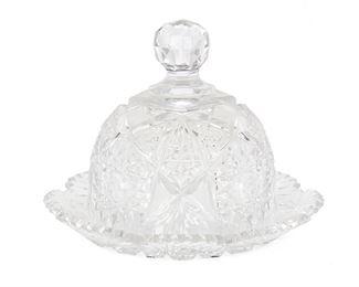 253
An American Brilliant Cut Glass Covered Butter Dish
Late 19th/early 20th Century
The Brilliant cut glass covered butter dish with hobstar and fan motif, fine crosshatching, faceted knob, and sawtooth scalloped edges
7" H x 9" Dia.
Estimate: $500 - $700