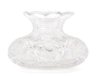 255
An American Brilliant Cut Glass Centerpiece Vase
Late 19th/early 20th Century
The Brilliant cut glass vase with bulbous body, pinched neck, and flared scalloped rim with hobstar and fan motif and ridge-cut paneled neck
7" H x 10" Dia.
Estimate: $600 - $800