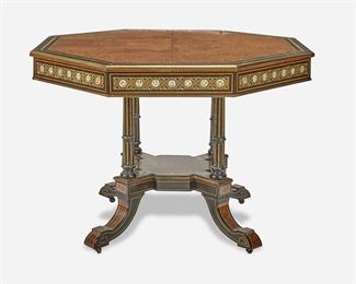 260
A Victorian Renaissance Revival Octagonal Table
Third-quarter 19th Century
The octagonal table with burlwood bookmatch parquetry top, ebonized and satinwood banded border, and gilt trim over a mounted apron with applied floral porcelain plaques enclosed in scrolled gilt-bronze framework supported by four fluted legs with incised gilt highlights joined by an X-stretcher raised overall on four swept legs with castors
29.875" H x 41.25" Dia.
Estimate: $1,000 - $2,000