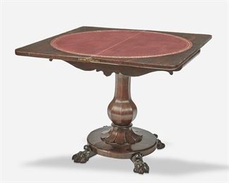 272
An English Rosewood Flip-Top Game Table
Second-quarter 19th Century
The game table with pivoting hinged flip-top with inset circular leather panel and concealed compartment over a carved apron supported by a tapered pedestal on a circular platform raised overall on four paw feet
Open: 27.75" H x 35.75" W x 34.875" D; Closed: 27.75" H x 36" W x 17.5" D
Estimate: $700 - $900