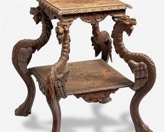 273
A Continental Carved Wood Side Table
Fourth-quarter 19th Century
The two-tiered side table with carved floral roundels against a basketweave patterned ground over acanthus leaf motif drops supported by four zoomorphic carved griffin legs with paw feet
27.5" H x 23.5" W x 22" D
Estimate: $500 - $700