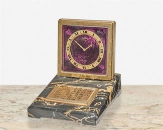 274
A Swiss E. Gübelin Art Deco Desk Clock And Calendar
Second-quarter 20th Century
Dial signed: E. Gubelin / Lucerne / 8 Days / Swiss
The gilt-bronze clock with a purple guilloche enamel face, black Roman numeral hour markers and minute track, and bronze eight day movement with gilt-bronze calendar on a black and white chamfered stone base
5.5" H x 4.5" W x 5.5" D
Estimate: $800 - $1,200