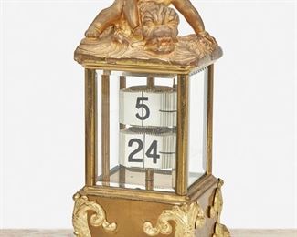 276
A French Gilt-Bronze Perpetual Desk Calendar
First-quarter 20th Century
Marked: France; Serial number: 1469
The gilt-bronze perpetual calendar with black Arabic numeral tiles in a glazed case surmounted by a putti riding a dolphin and raised on four dolphin feet
8.5" H x 4" W x 4" D
Estimate: $600 - $800