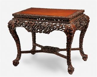 277
A Chinese Carved Wood Console Table
19th Century
The carved wood console table with inlaid top enclosed by a carved border over an elaborate openwork apron with dragon motifs supported by four zoomorphic dragon legs joined by an X-stretcher raised overall on ball-and-claw feet
30" H x 39.5" W x 25" D
Estimate: $2,000 - $3,000