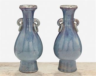 278
A Pair Of Chinese Flambé Glazed Porcelain Vases
Late Qing Period (1644-1912)
Each vase with lavender and blue flambe glaze, bulbous tapered body, flared neck, and double ring handles raised on a tapered foot, 2 pieces
Each: 10" H x 4.25" Dia.
Estimate: $800 - $1,200