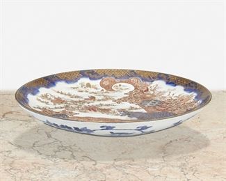 283
A Large Japanese Imari Porcelain Charger
Tenpo Period (1830-1844)
The circular Imari ware charger depicting a pastoral figural scene with shippo and kikko patterning in blue underglaze with red and gilt enamel overglaze, blue underglaze scrolling foliage to reverse, and gilt border
2.75" H x 18.75" Dia.
Estimate: $500 - $700