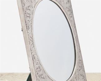 290
An American Sterling Silver Framed Table Mirror
First-half 20th Century
Marked for William B. Kerr & Co.; Further marked: Sterling / 3481
The rectangular sterling silver easel-back frame with scrolling foliate motif and cartouche to bottom enclosing an oval mirror
18" H x 14.75" W x 6.75" D
29.3 oz. troy approximately
Estimate: $600 - $800