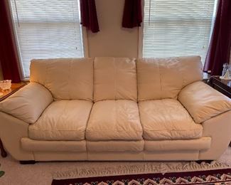 Leather cream colored sofa is excellent condition