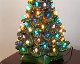 Item #12: $65. Vintage ceramic lighted Christmas tree with music box too...plays White Christmas. Missing about 7 plastic light pegs. 19" ht