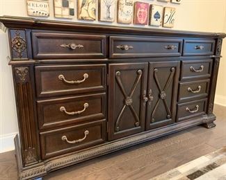 Dark Walnut Dresser.  (Used as a buffet here).  Comes with matching mirror.  Top drawers felt lined with 6 pull-out drawers (cedar).  Center console for storage. (Ashley Furniture). $300 for dresser & mirror set.