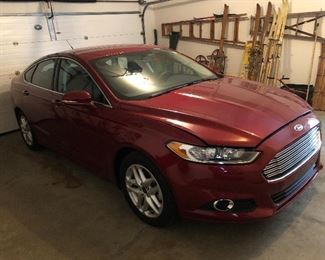 2014 Ford fusion SE 3720 miles. Interior is like new. There is a dent in the trunk lid as shown in pictures. Sorry folks I have added another picture of the car at the bottom of the photographs. The vehicle is in a dimly lit garage just noticed these dents in the drivers door. My apologies
