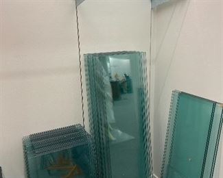 Glass shelving with arms, also metal bars and wooden shelving.