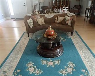 Suede sofa, area rug, elephant coffee table 