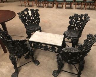 Heavy old cast iron garden chairs and marble top table. One chair needs a little repair