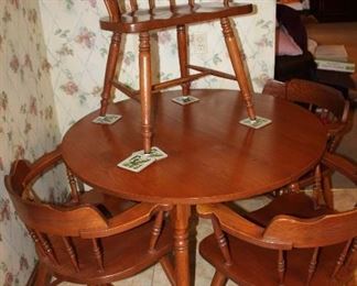 round dining table and three chairs