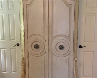 whitewashed wood armoire with metal scroll work