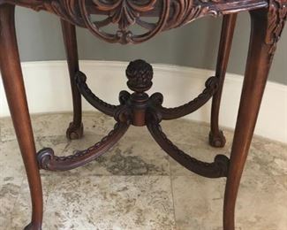 Antique English mahogany center table with carved apron, ball-and-claw feet