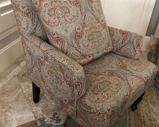 Pair of paisley print upholstered armchairs with throw pillows