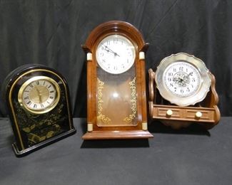 3 Clock Lot
Description 	
Vintage Clocks - all Plastic
Wall Clock - Brown - 18" tall
Wall Clock - Plate Rack with Plate - 14.5" tall
Table Top Black and Gold Clock -  Floral Design with Small Drawer at the Bottom -12" tall
Batteries not included
UPS STORE PACKING & SHIPPING