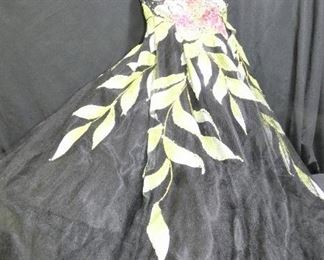 Shimmering Black & Green Ball Gown, Prom Dress
Description 	
- Back Laces Up - Large Flower and Leaves on Front
- Size 14 
- Strapless - Lots of Crinolines
- By Macduggal
UPS STORE PACKING & SHIPPING