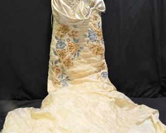 New With Tags Ruched Ball Gown / Prom Dress
Description 	
- Size 14 
- Made by E. Dresses - Light Gold Color with Gray Flowers
- Bow on Front - Bodice is Ruched
SHIPPING AVAILABLE