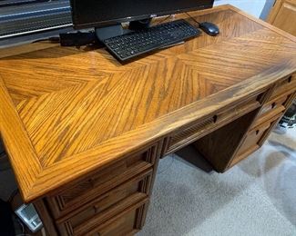 Wood Office Desk with seven drawers. Beautiful looking desk with slight wear to the finish/mainly near the edge of the desk. Measures 51" x 23.5" x 30". This item is located on the second floor of the home.