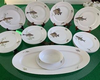 KPM Krister (Germany) Platter and Plates. Beautiful fish motif. This fun lot includes a platter, gravy dish and 12 plates in four different patterns. No noticed chips or cracks. The platter measures 24" x 9"