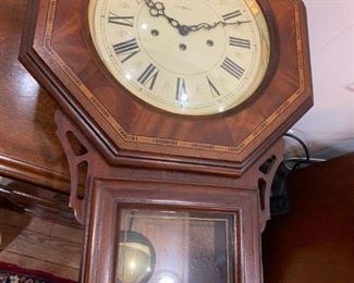 #23	Howard Miller Wall Clock w/key (front open) inlaid around clock face  25.5x16.5x5   Model  612-210	 $125.00 
