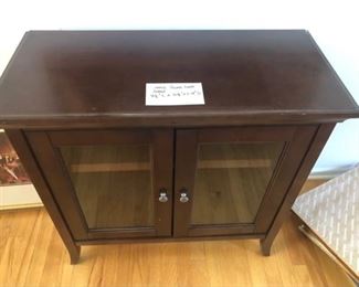 Small wood cabinet with glass doors $75 (Photo 1/2)