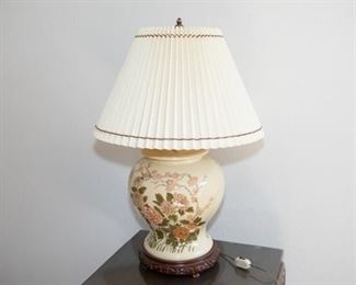 Chinese Style Flowered Ceramic Table Lamp. Yellow, floral, blossom lamp with wood carved base. 20”H x 19.5”W approximate. Good condition.