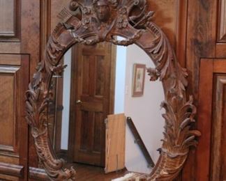 Ornate wood mirror with ladies face