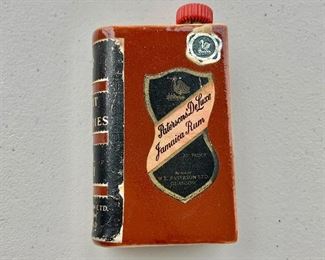 $20 - Miniature book-shaped porcelain flask, "Patterson's DeLuxe Jamaican Rum," WR Paterson Ltd. Glasgow Scotland; 3 1/2 in. (H) x 2 1/4 in. (W) x 1 in. (depth)