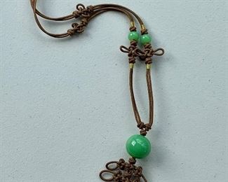 $24 - Woven knots and green beads necklace;