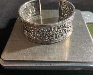 Sterling bracelet - 2 1/2 inches at its widest - weighs 44.6 grams - price 60 dollars 