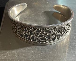 sterling bracelet - 2 1/2 inches at widest - weighs 36.9 grams - price 75 dollars  