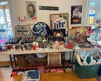 Various Coca-Cola collectibles beer advertisement signs vintage man cave items.