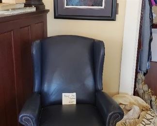 Navy blue leather recliner, framed art