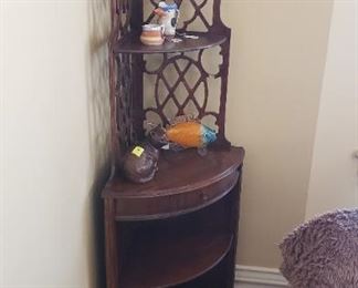 corner cabinet with lattice work and one drawer