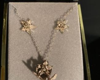 Silver necklace and earrings.