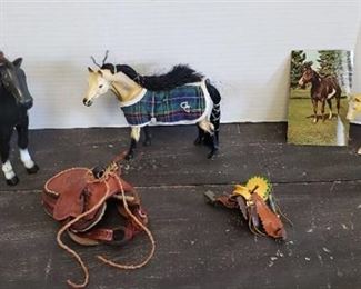 2 Plastic Horses, 1 Rubber Horse and 2 Toy Saddles (one is leather)