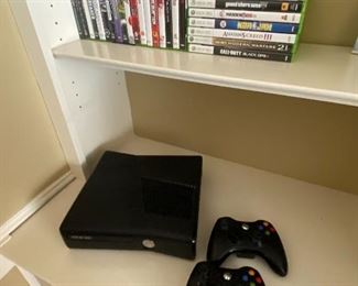 Xbox 360 console, connector cables, and controllers.