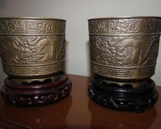 $100 pr. Pair of Mongolian brass vases/plant pots and stands.