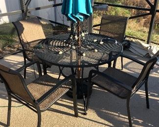 Metal table , 4 chairs, umbrella, and stand $125