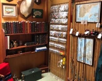 Leather bound books on wars across the ages, collectible fishing lures, rods and reels. Tackle boxes and vintage minnow fishing bucket