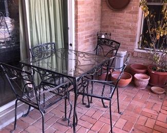 Vintage patio set. Heavy gauge wrought iron. Thick polished edge glass top. Mid century.
