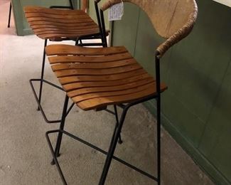 Arthur Umanoff for Raymor. Set of 2 wrought iron and sculptural rush back barstools with maple slat seats. Mid Century.